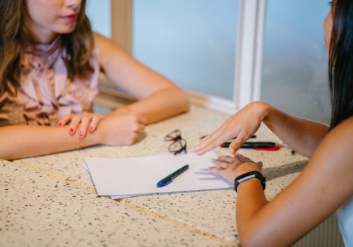 Two people sitting together across a table